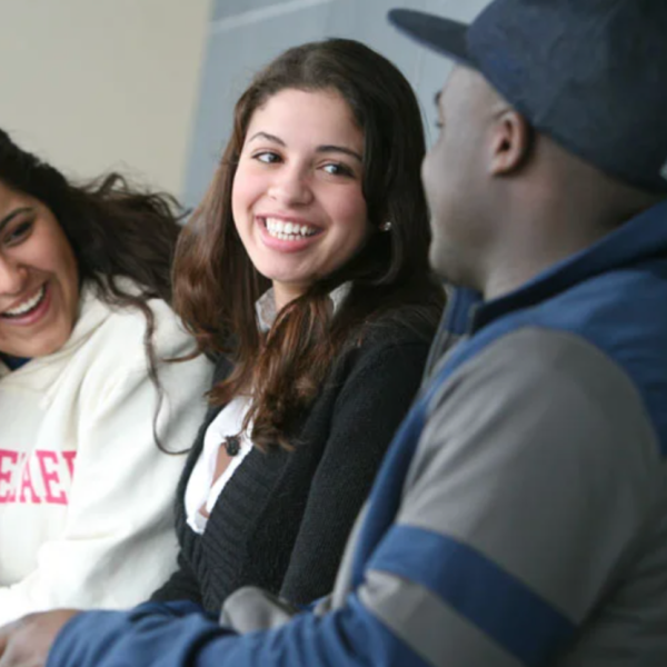 students talking while sitting on a bench