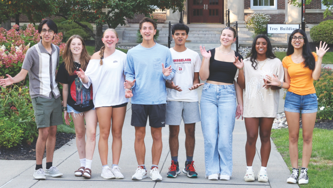 Happy students in front of the Troy Building